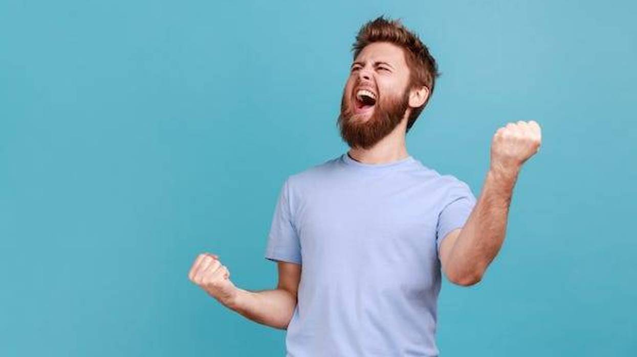 Bearded man screaming against blue background