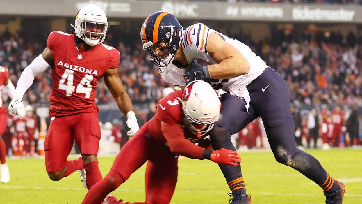 Bears tight end Cole Kmet, right, makes a reception against the Cardinals.