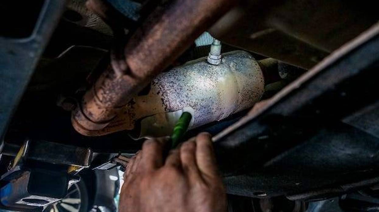 Beck's Garage mechanic, Randal Lonkerd, points out a catalytic converter on a vehicle as he talks about the rise in converter theft
