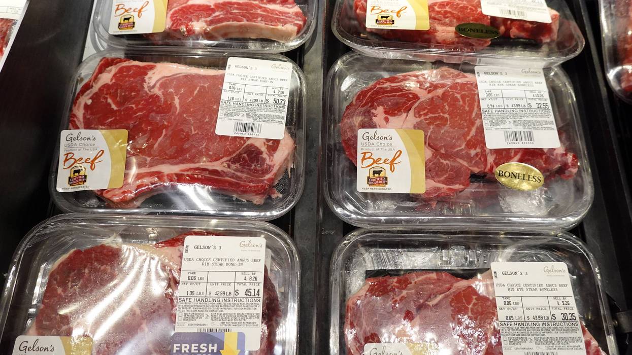 Beef ribeye steaks are displayed at a grocery store on April 06, 2026 in Los Angeles, California. Amid persistently high food inflation, the price of a pound of ground beef has risen to between roughly $6.49 and $8.96, often exceeding the federal minimum wage of $7.25 an hour, as supply shortages, drought, and disease affecting cattle herds drive costs higher while wages remain unchanged since 2009.