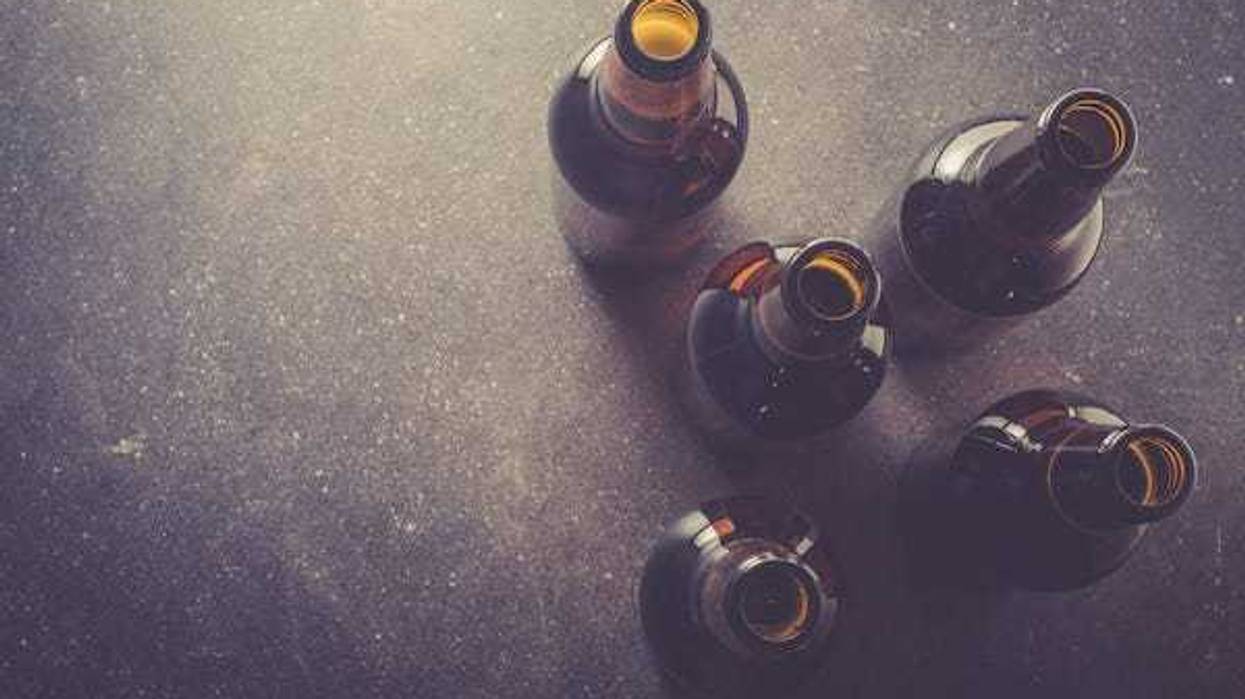 Beer bottles resting on a dark table