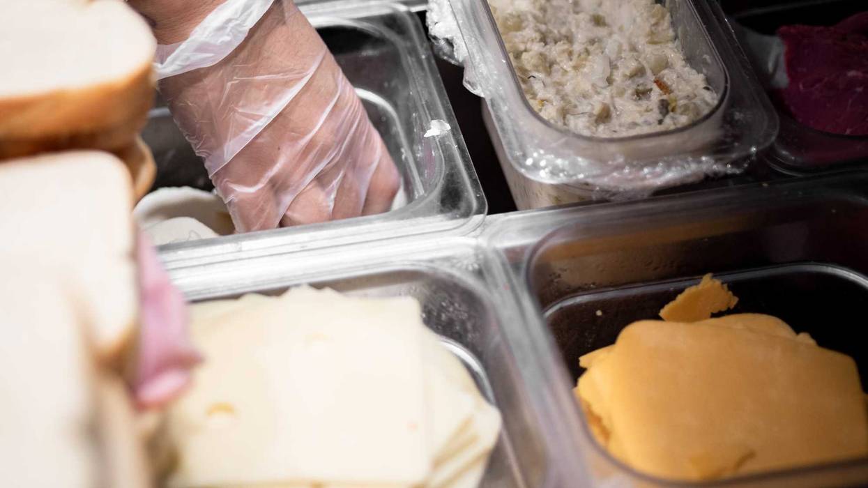 Behind the counter of a sandwich shop.