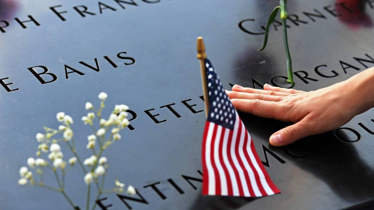 BEIJING, Sept. 13, 2019 (Xinhua) -- A woman touches a plate on which names of 9/11 victims were inscribed at the National September 11 Memorial and Museum in New York, the United States, Sept. 11, 2019.