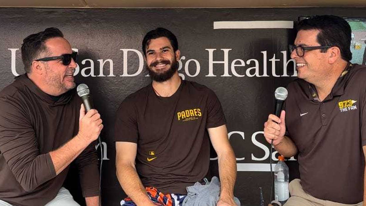 Ben and Woods talk with Padres starting pitcher Dylan Cease down in the dugout prior before Wednesday's game at Petco Park against the Colorado Rockies