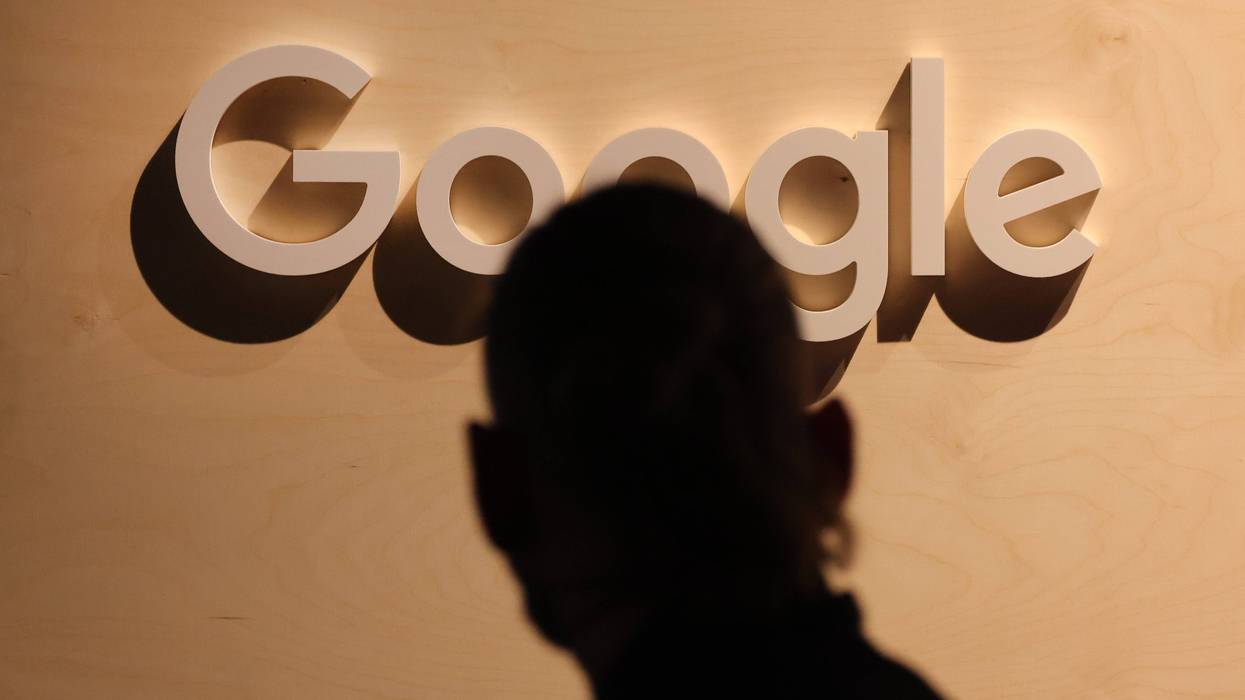 BERLIN, GERMANY - JUNE 09: A participant wearing an earring walks past a Google logo at a stand at the 2022 Re:publica digital society festival on June 09, 2022 in Berlin, Germany. The three-day event brings together stakeholders and leading voices from a wide spectrum of today's global, digital society.
