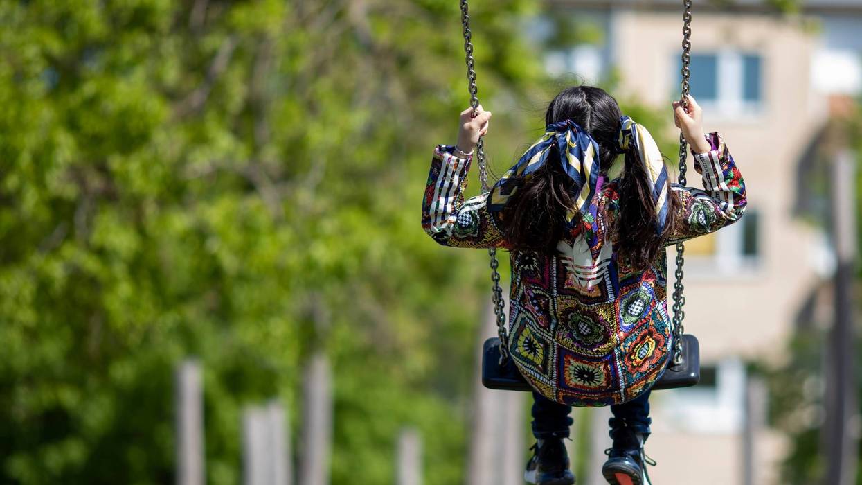 BERLIN, GERMANY - MAY 06: A girl swings at re-opened playground during the coronavirus crisis on May 06, 2020 in Berlin, Germany.