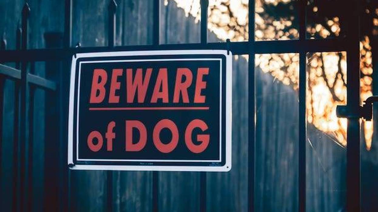 "Beware of Dog" sign on fence
