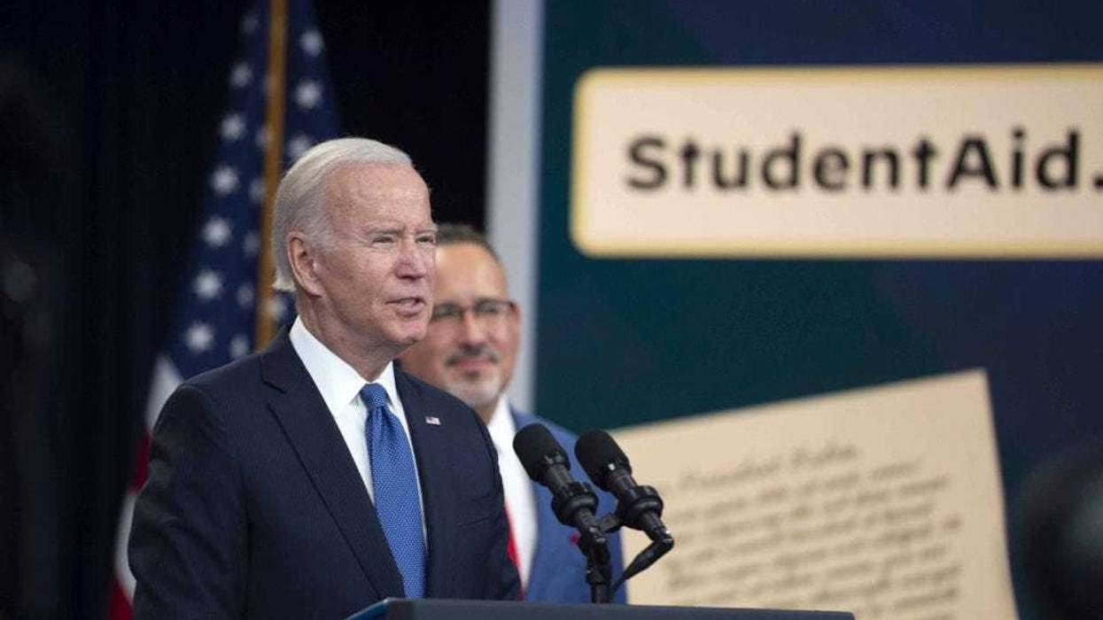 Biden speaks as Miguel Cardona, US secretary of education, right, listens in the Eisenhower Executive Office Building in Washington, on Monday, Oct. 17, 2022. Biden said eight million borrowers applied for the student debt relief program during a beta test to receive up to $20,000 in debt cancellation and that the official website is up and available for use.