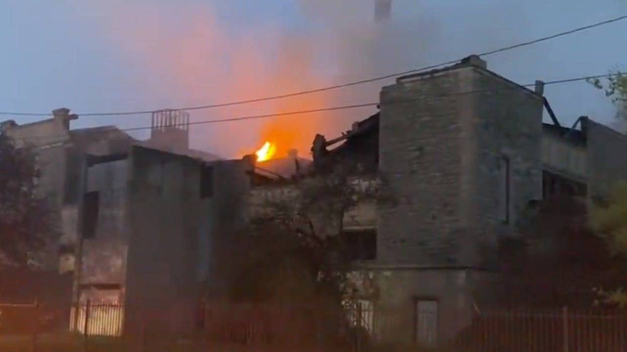 Big building with flames coming out of top