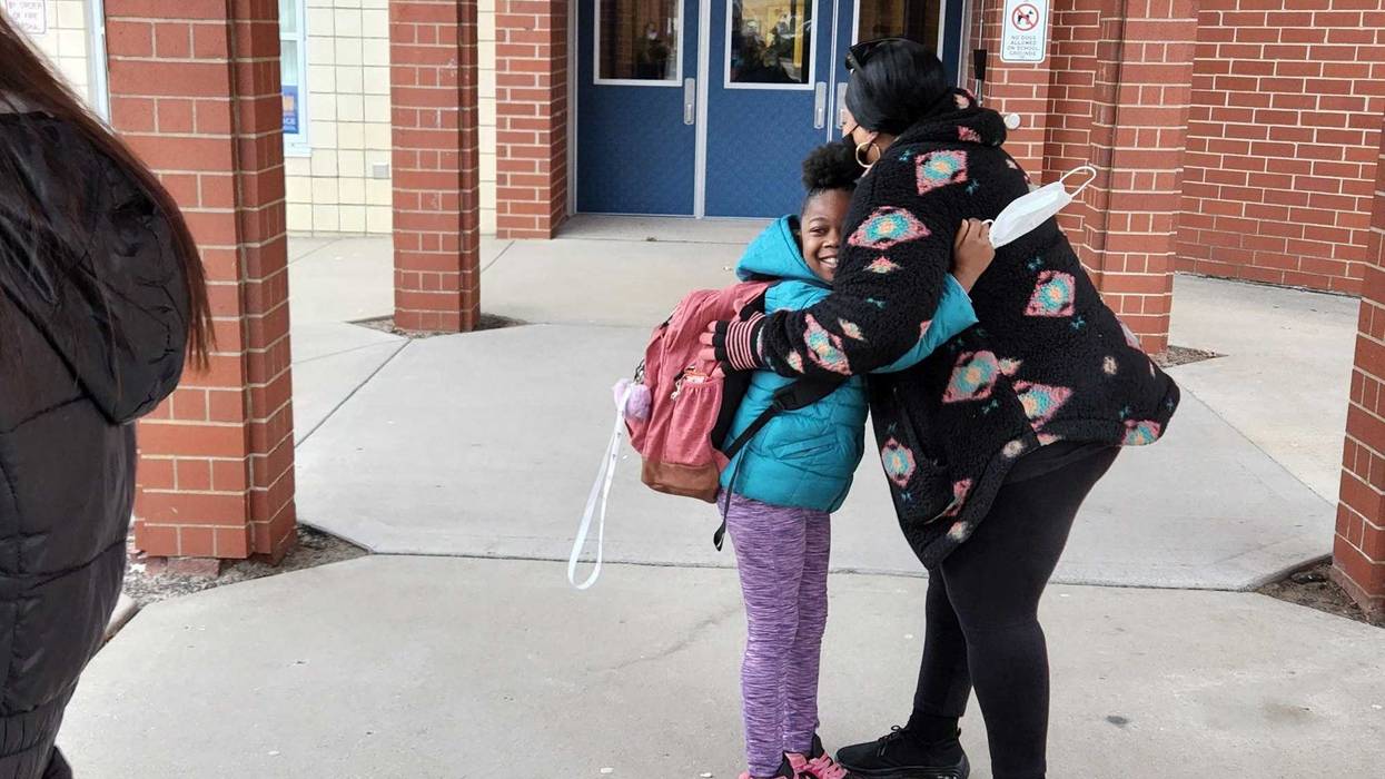 Big hug on first day back to school after strike