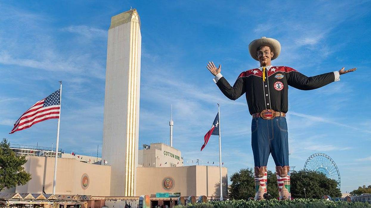 BIG TEX CIRCLE WITH TOWER BUILDING IN BACKGROUND