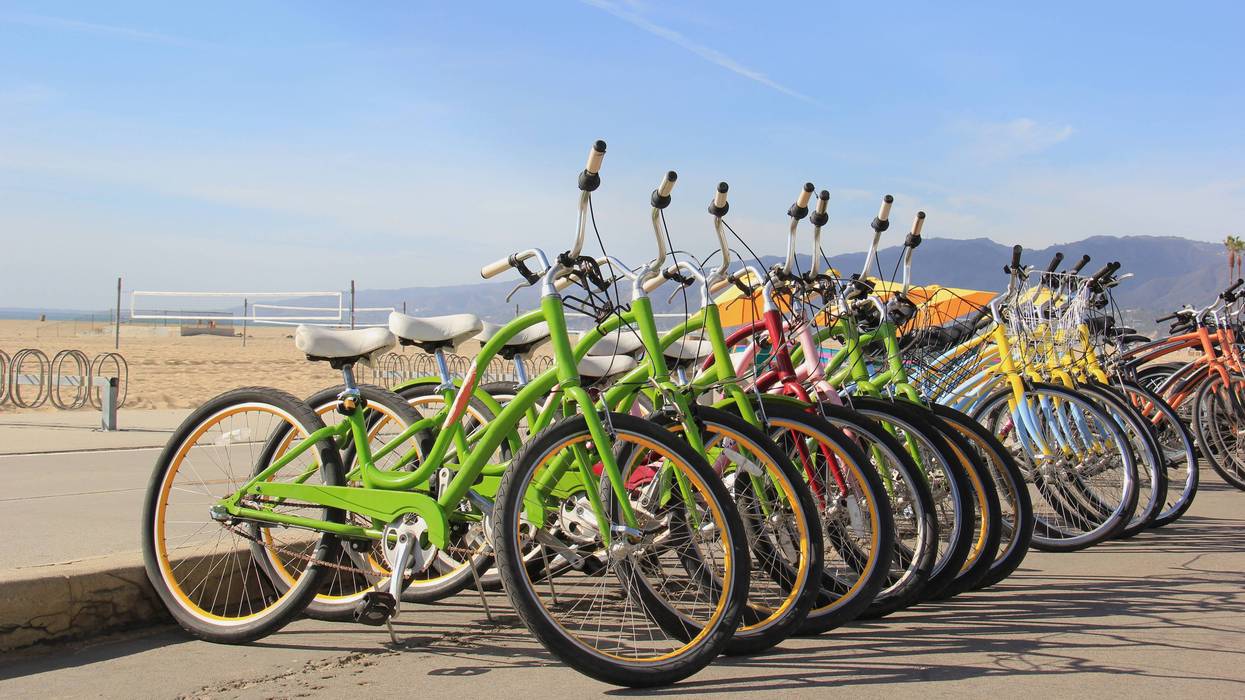 bikes parked on curb at beach