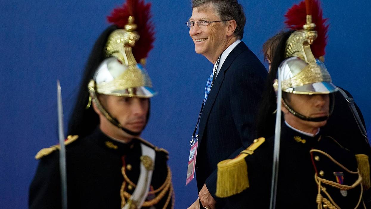 bill gates stands with soldiers