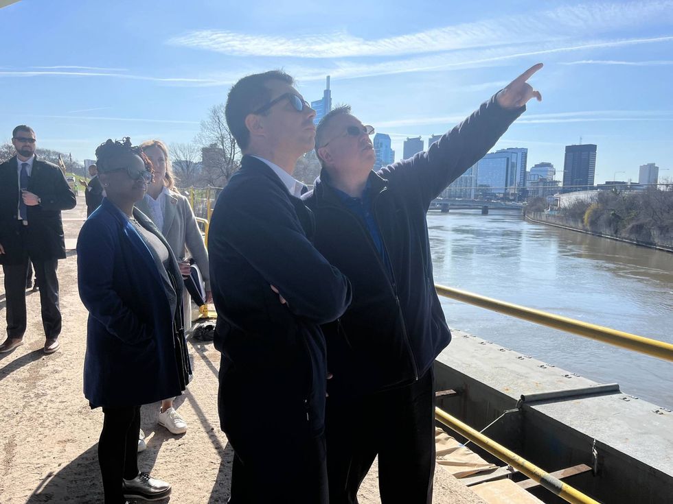 Bill Gural, chief construction engineer with the Philadelphia Streets Department, leads Transportation Secretary Pete Buttigieg on a tour of MLK Drive Bridge