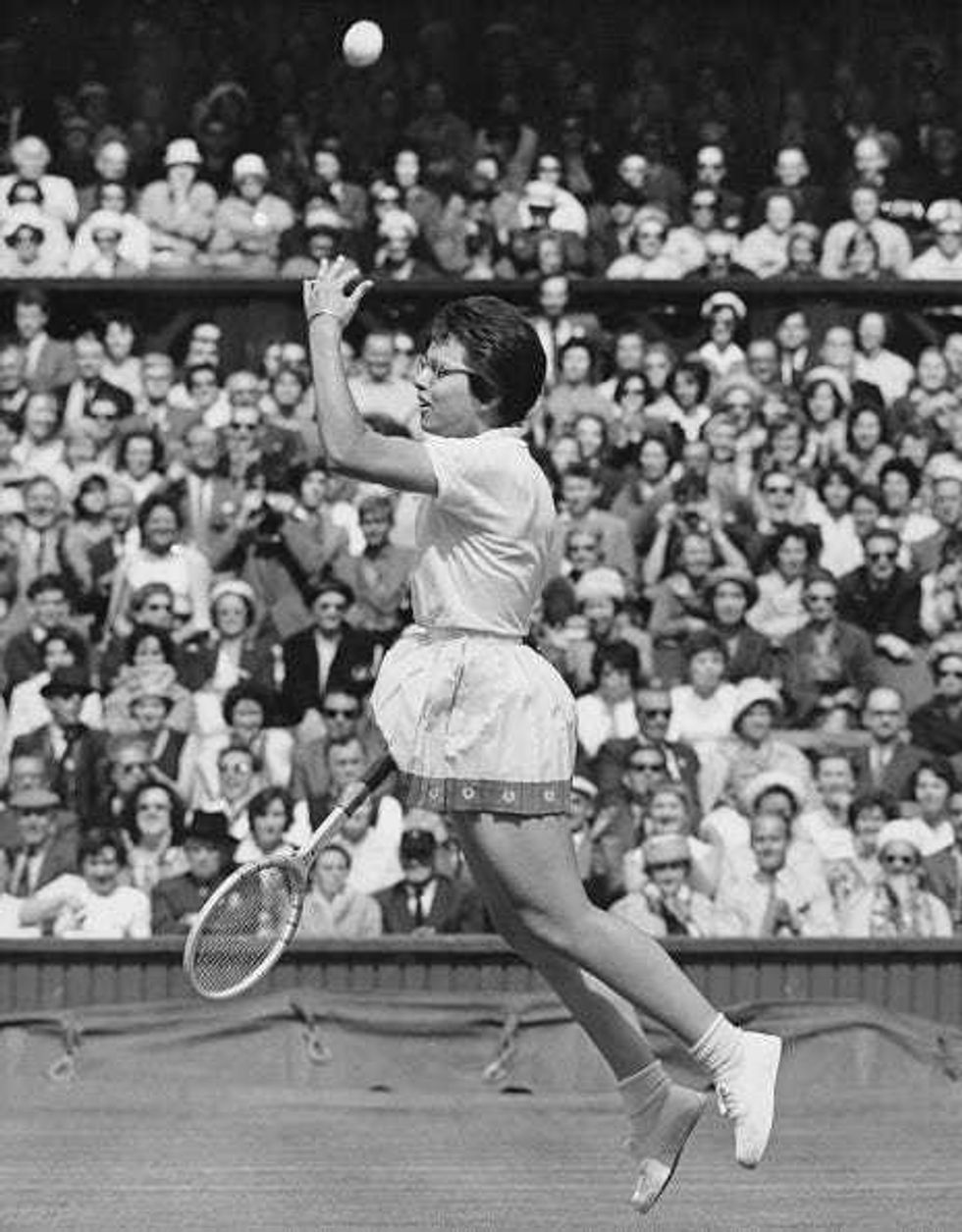 Billie Jean Moffitt of the United States throws the tennis ball away as she jumps into the air in celebration after defeating Margaret Court of Australia in their Women