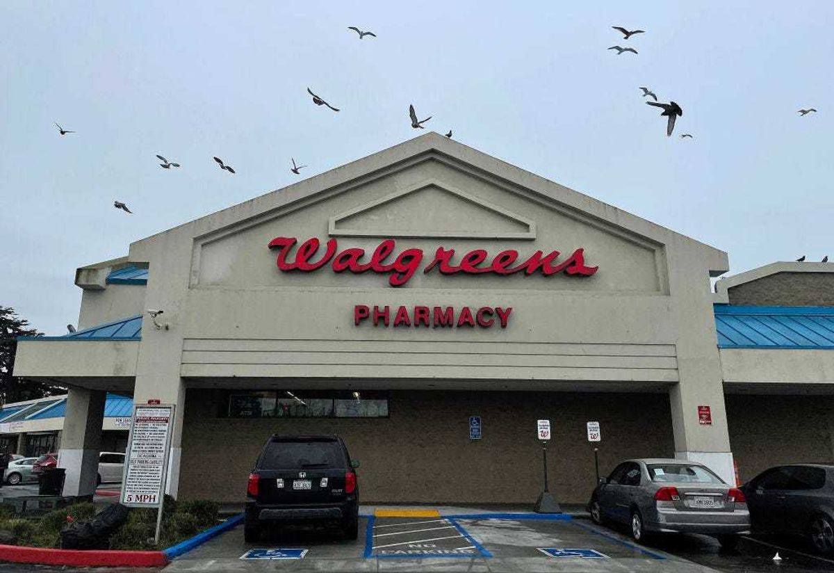 Birds fly by a sign posted on the exterior of a Walgreens store on March 09, 2023 in Richmond, California.