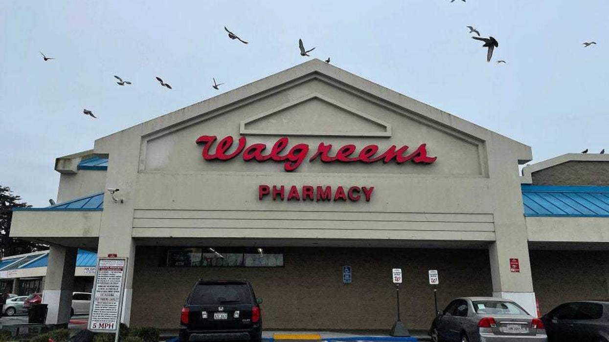Birds fly by a sign posted on the exterior of a Walgreens store on March 09, 2023 in Richmond, California.