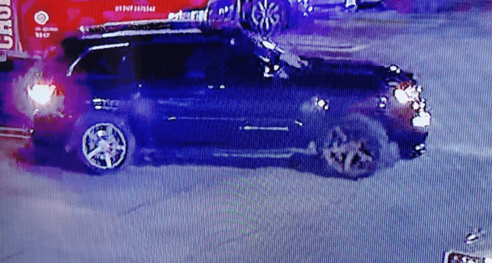 black colored Jeep Cherokee with chrome trim around rear passenger windows