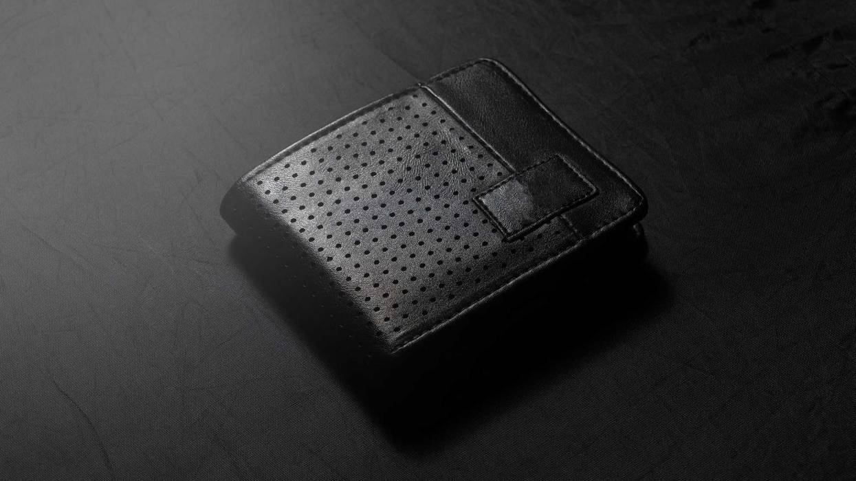 black leather wallet on dark background low key photo
