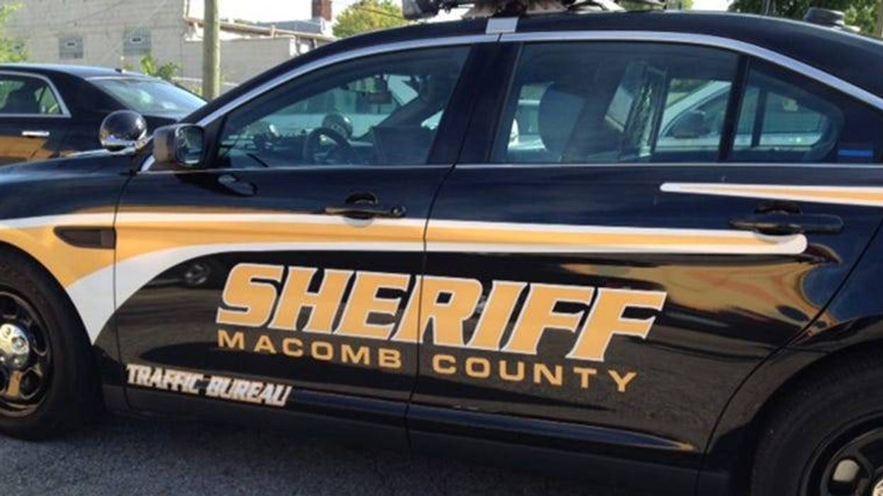 Black Macomb County Sheriff patrol car with gold "SHERIFF MACOMB COUNTY" and "Traffic Bureau" text.