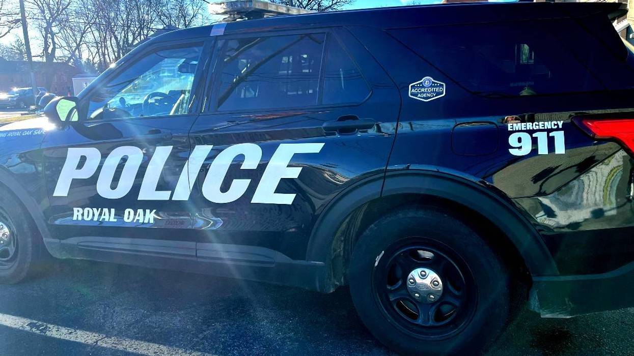 Black Royal Oak Police SUV with roof lights, 'POLICE', and 'EMERGENCY 911' visible on its side.