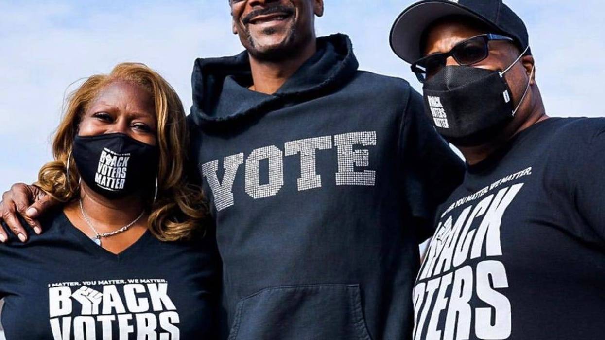 Black Voters Matter Fund co-founders LaTosha Brown (l) and Cliff Albright (r) with Snoop Dogg during a recent voter registration even in California