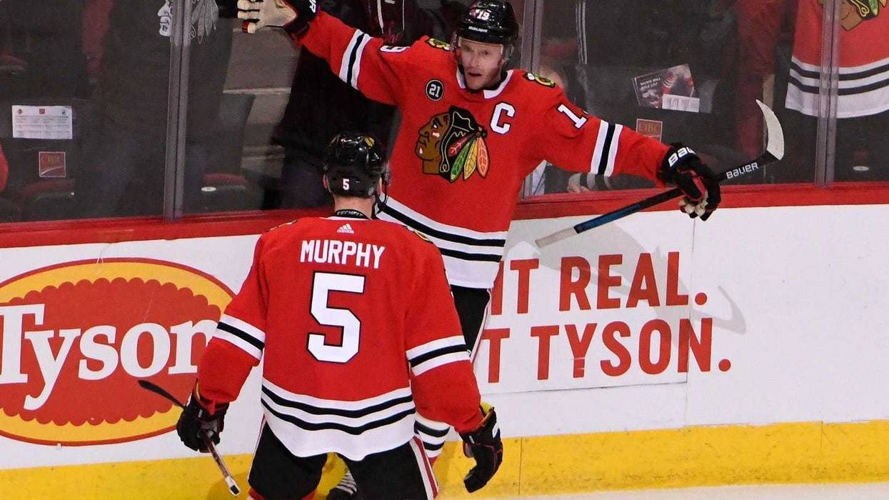 Blackhawks center Jonathan Toews (19) celebrates with defenseman Connor Murphy (5) after scoring the game-winning goal against the Canucks in overtime.