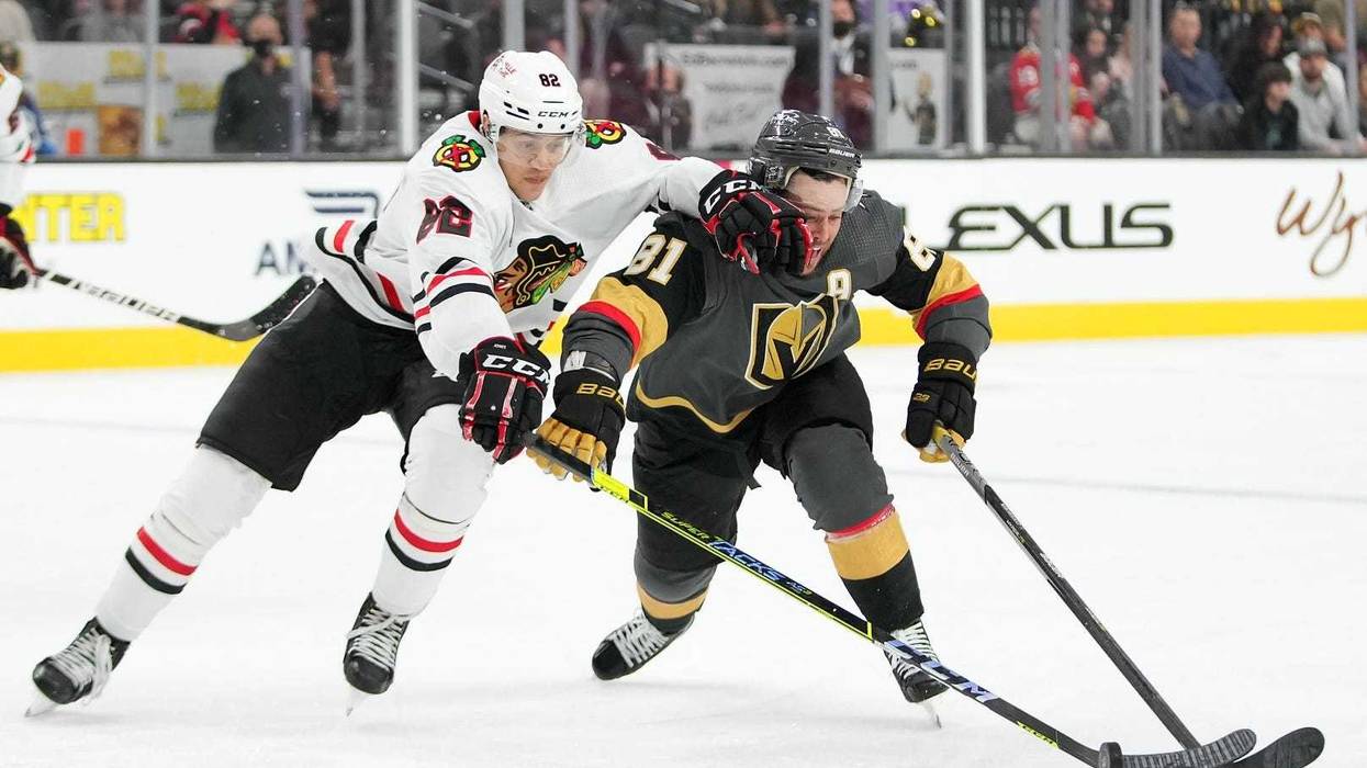Blackhawks defenseman Caleb Jones (82) intercepts the puck from Vegas Golden Knights center Marchessault (81).
