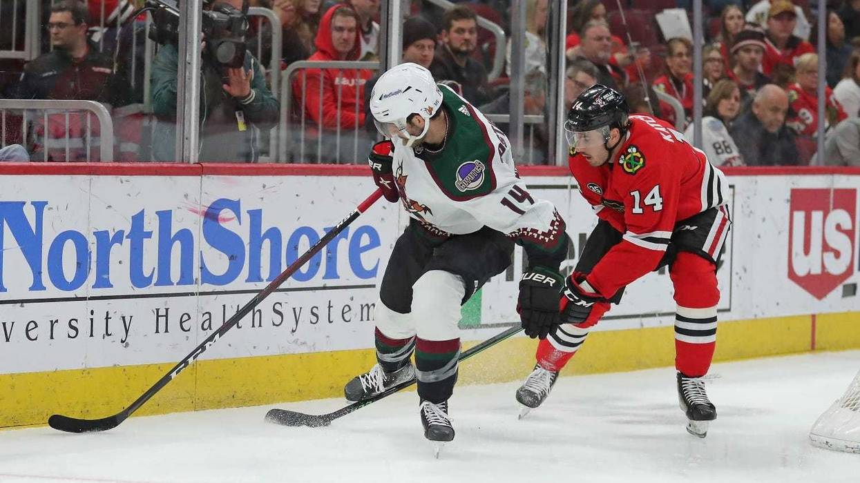 Blackhawks left wing Boris Katchouk (14) steals the puck from Coyotes defenseman Shayne Gostisbehere (14).