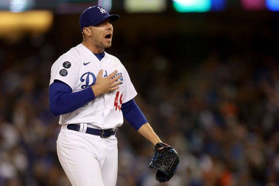Blake Treinen #49 of the Los Angeles Dodgers reacts after a strikeout against the San Francisco Giants during the eighth inning in game 3.