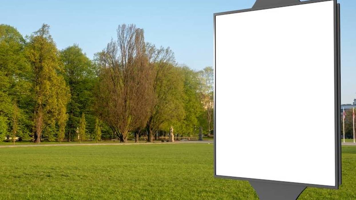 Blank mock up of vertical street poster billboard on city background