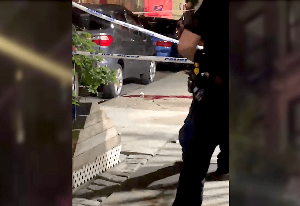 Blood is seen on the sidewalk of a fatal shooting at 230 West 140th St. in Harlem on June 19