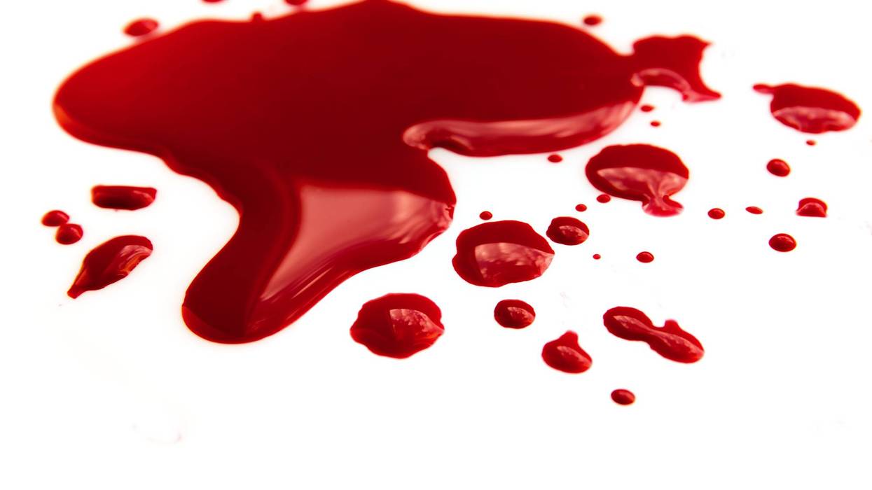 Blood stains (puddle) isolated on white background close up, horizontal
