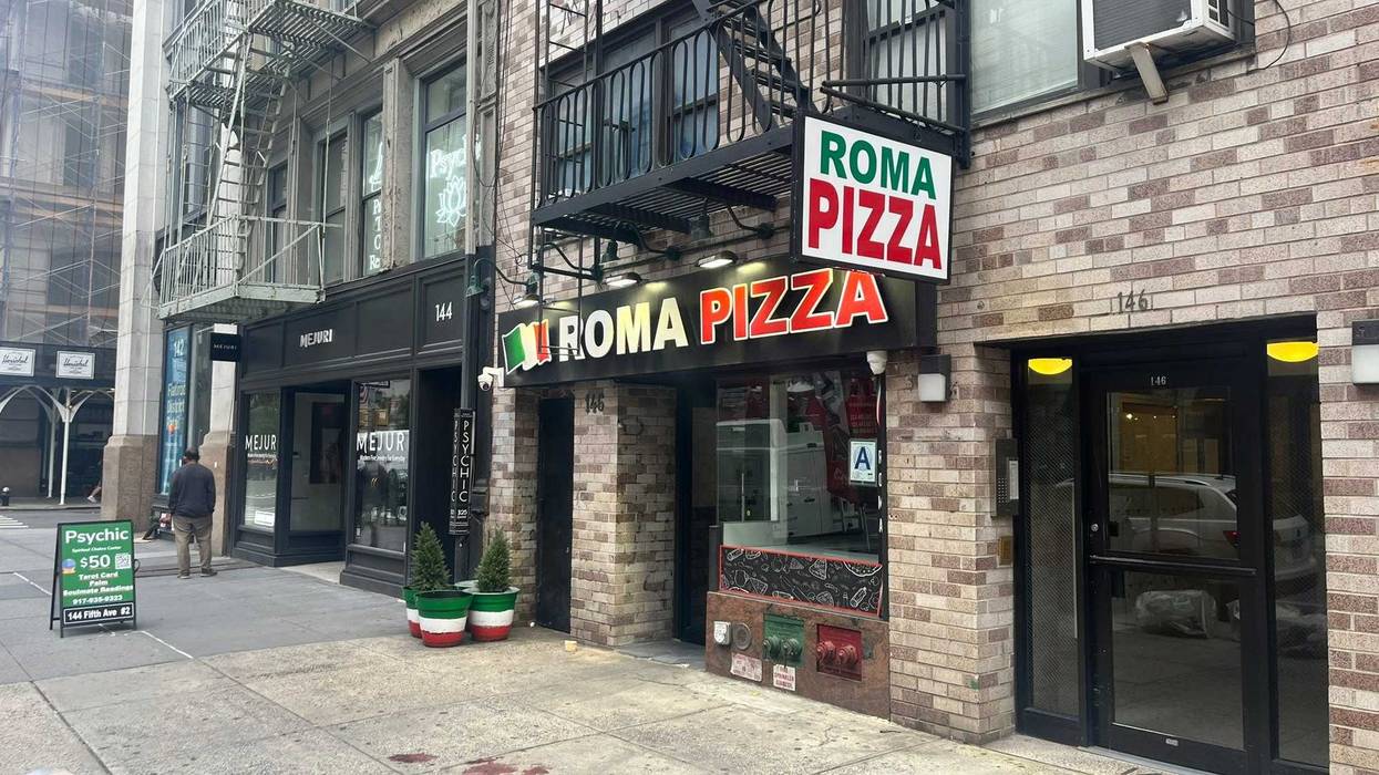 Blood was still on the sidewalk outside Roma Pizza on Tuesday morning