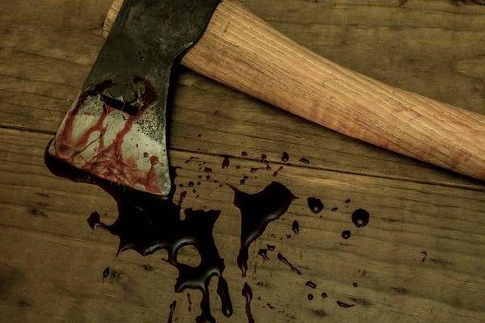 Bloody ax on wooden floor