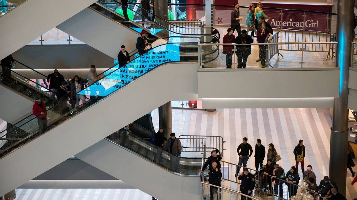 BLOOMINGTON, MN - DECEMBER 23: Mall goers and police queue up to around the rotunda of the Mall of America waiting for the planned Black Lives Matter demonstration on December 23, 2015 in Bloomington, Minnesota. Black Lives Matter Minneapolis staged a brief protest at the Mall of America in Bloomington, MN before moving their protest to the airport.