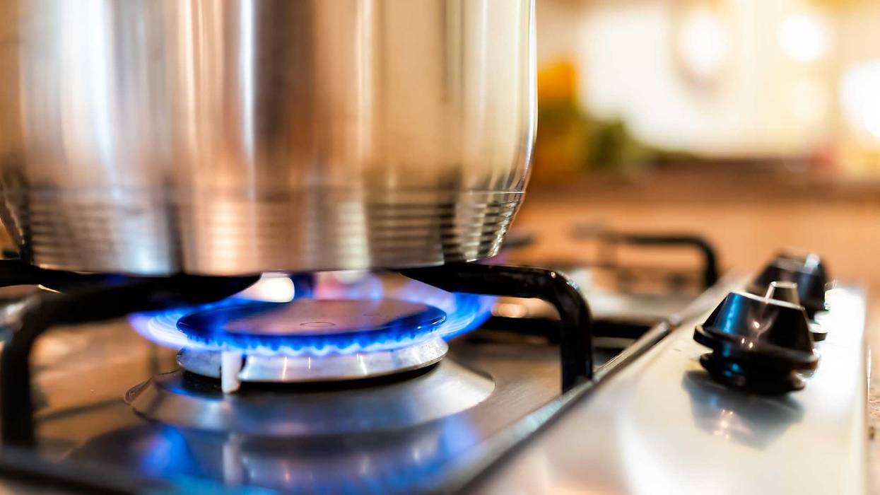 Blue fire under pot on a stove top