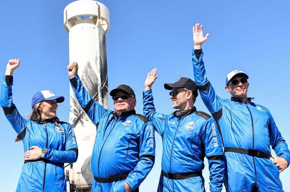 Blue Origin vice president of mission and flight operations Audrey Powers, Star Trek actor William Shatner, Planet Labs co-founder Chris Boshuizen and Medidata Solutions co-founder Glen de Vries wave during a media availability on the landing pad of Blue Origin