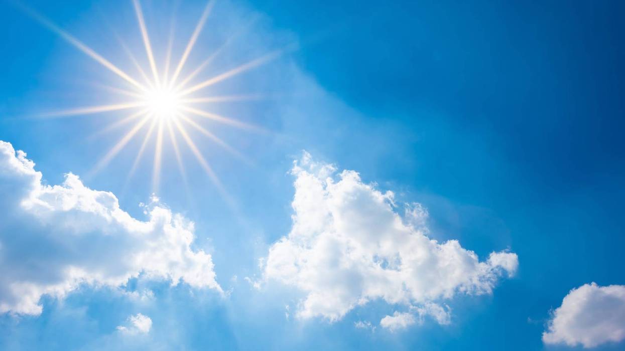 Blue sky with bright sun and clouds