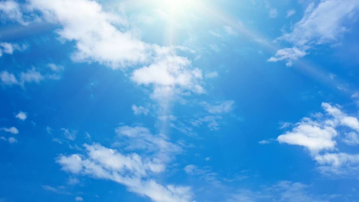 Blue sky with white clouds and bright sun.