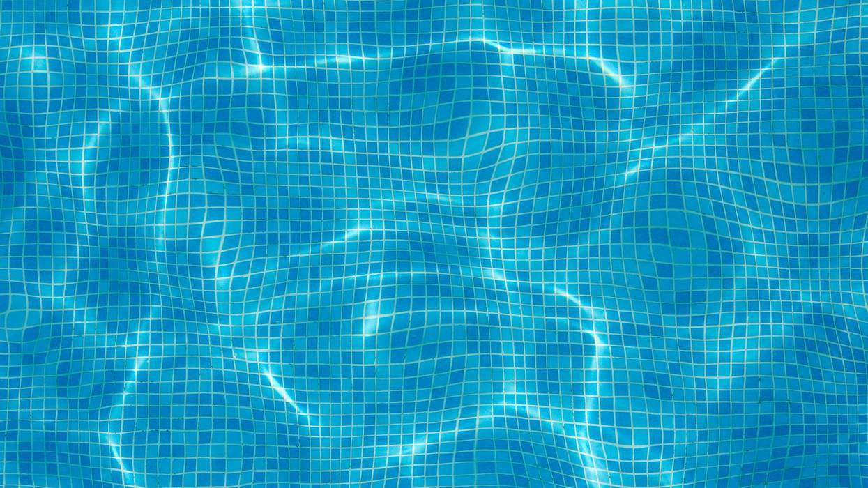 Blue water of the pool. Background. Selective focus.