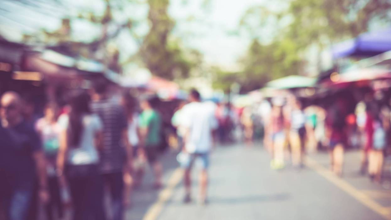 Blurred background : people shopping at market fair in sunny day, blur background with bokeh.