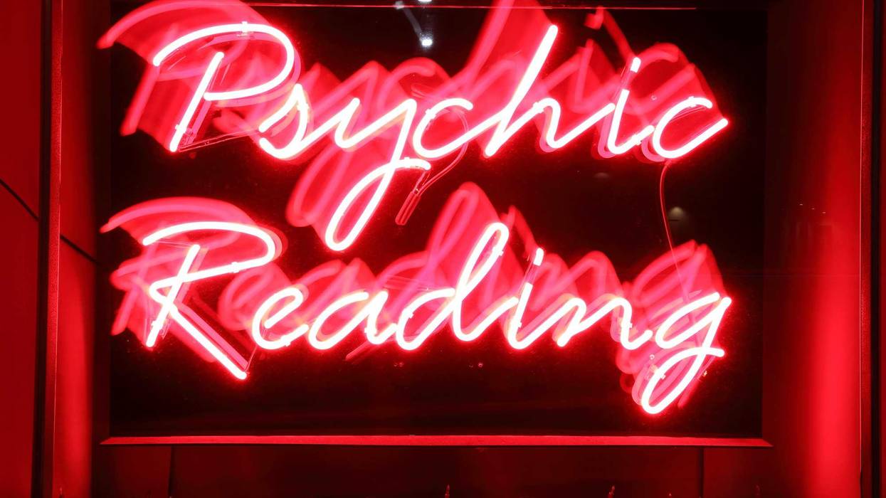 Blurred camera pan of a red neon business sign