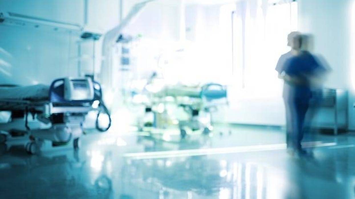 Blurred emergency room with walking staff, unfocused background