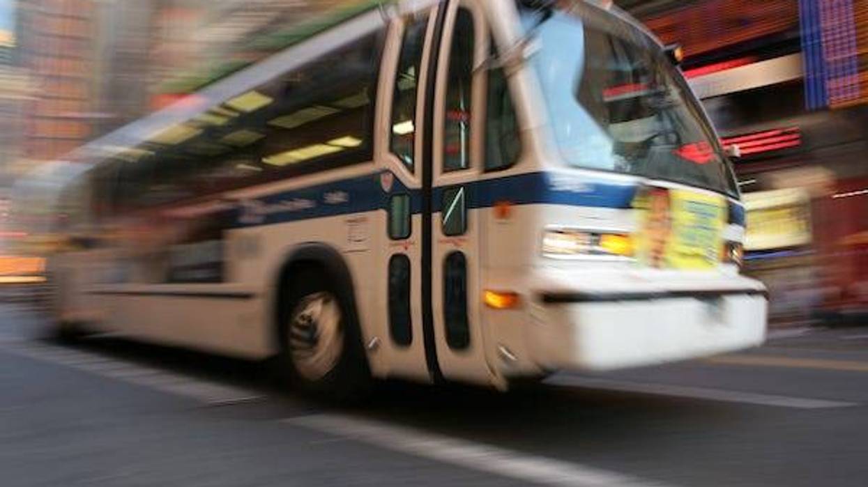 Blurry image of a bus speeding through a city