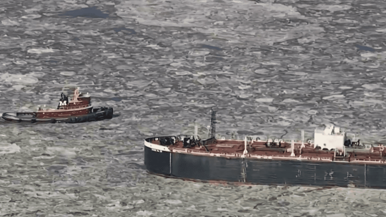 Boats navigating through chunks of ice in Delaware River
