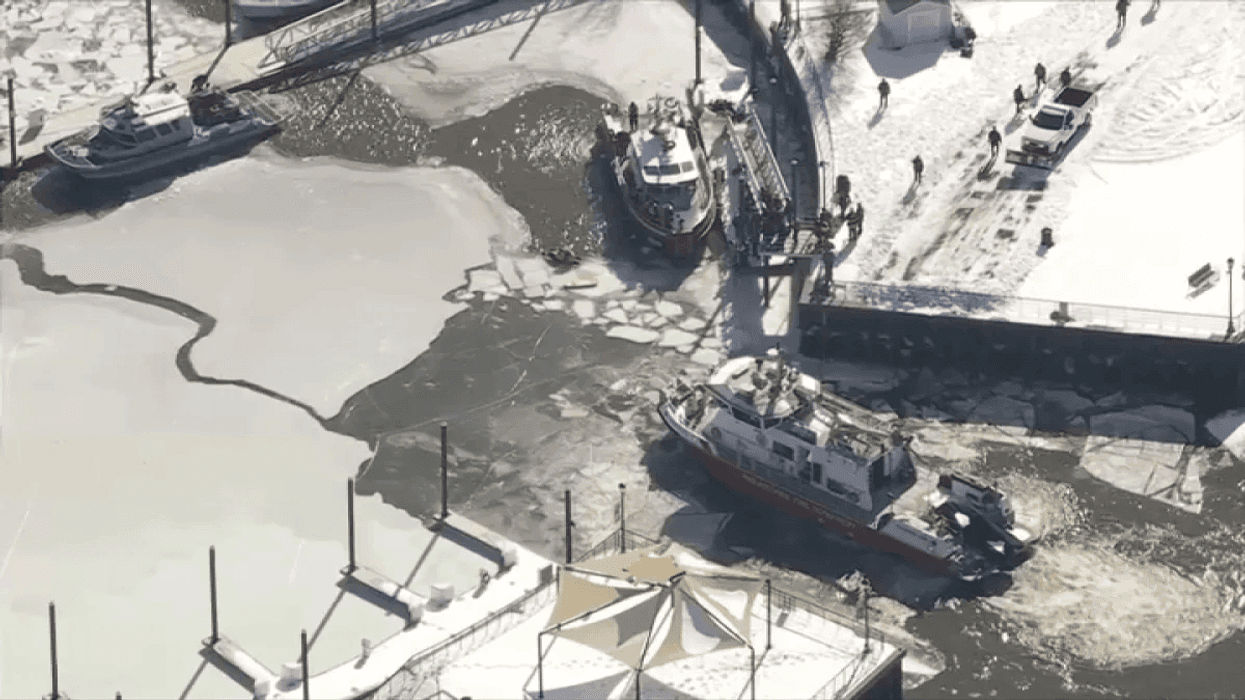 Boats search an icy Delaware River for the Camden firefighter, who fell in the river and went under the ice around 11 a.m.