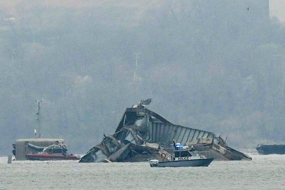 Boats work near wreckage of the Francis Scott Key Bridge on Wednesday, March 27, in Baltimore.