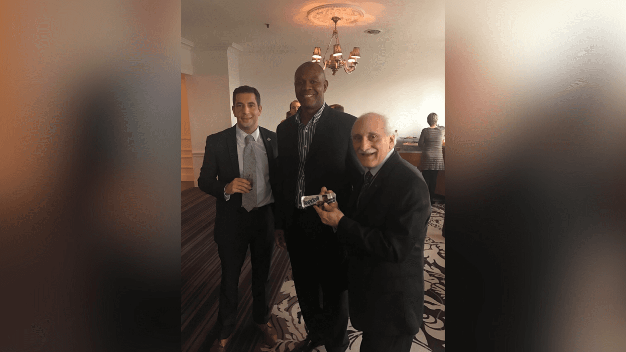 Bob and Marc Virga with Eagles legend Randall Cunningham, getting him to sign a very old "Randall bar" that Bob saved.