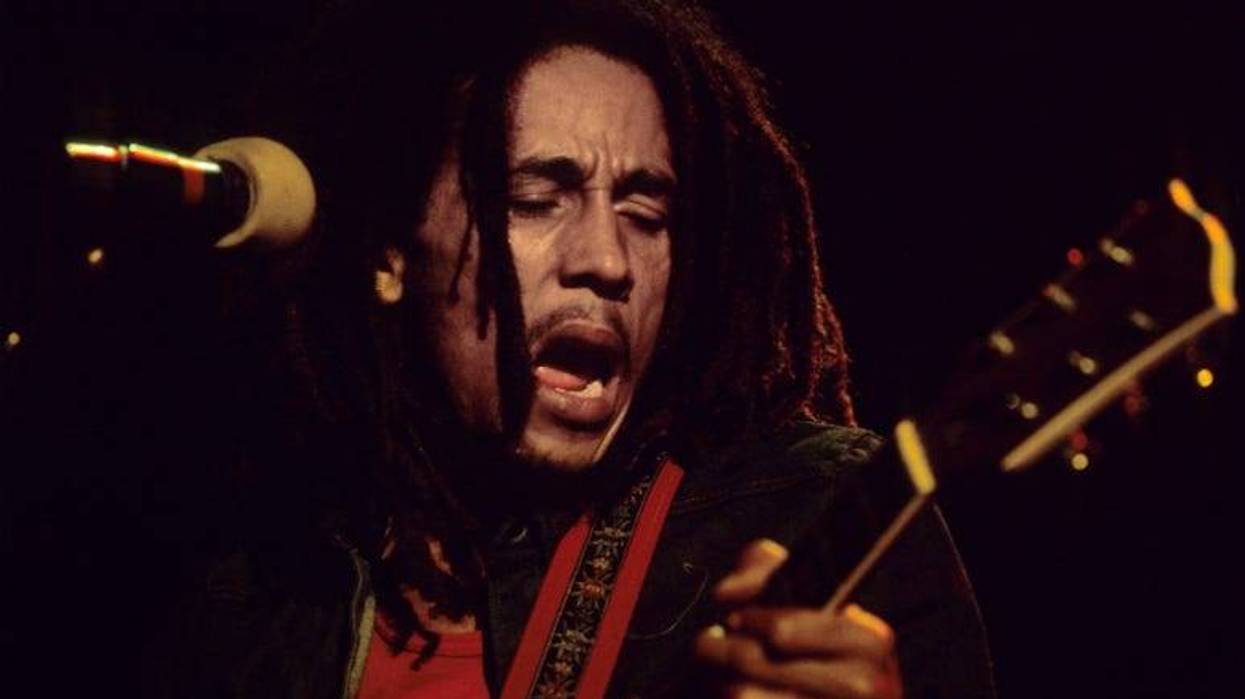 Bob Marley plays his guitar on stage during a gig at the Hammersmith Odeon, London